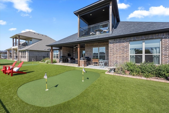 rear view of house with a patio and a balcony