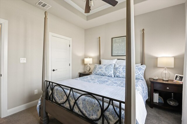 bedroom featuring carpet, ceiling fan, and a tray ceiling