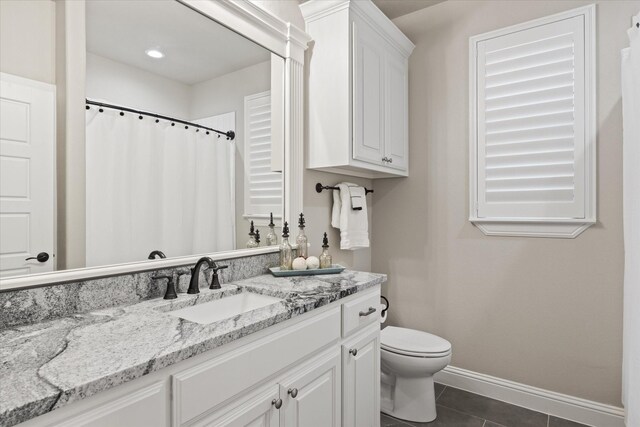 bathroom with vanity, tile patterned floors, and toilet