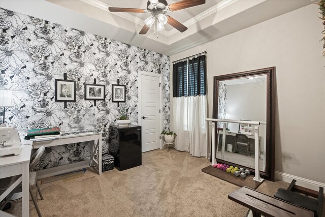 office area with light carpet, a raised ceiling, ornamental molding, and ceiling fan