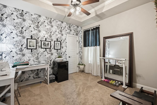 office area featuring light carpet, a tray ceiling, crown molding, and ceiling fan