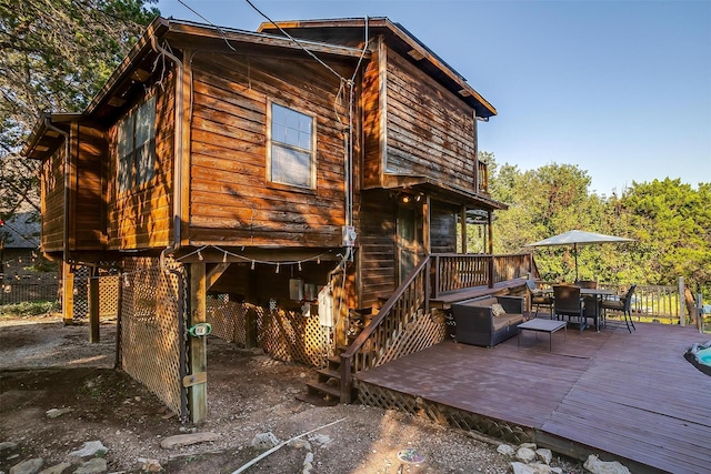 back of house with a wooden deck