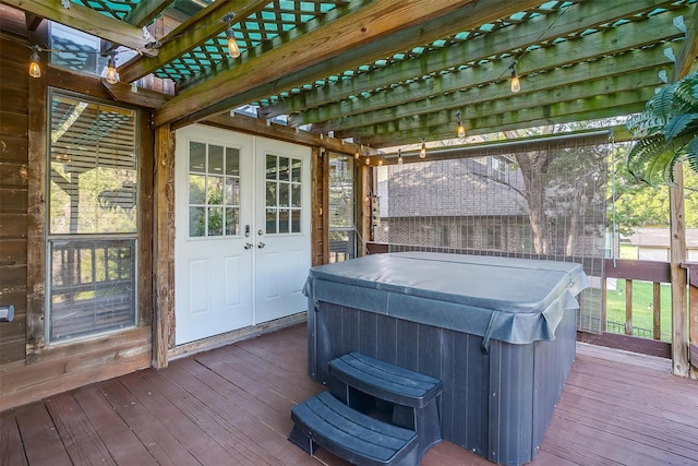 wooden terrace featuring a hot tub and french doors