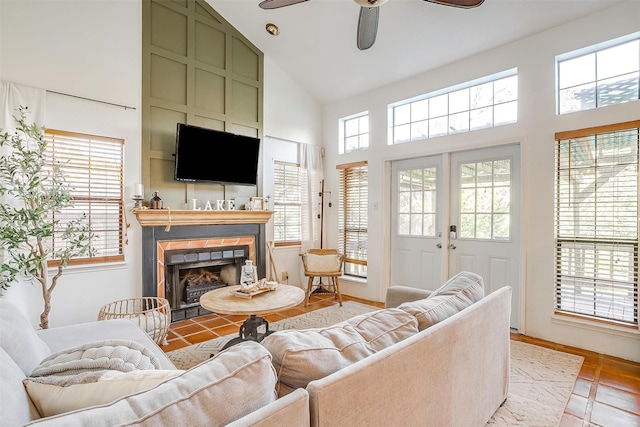 living room with french doors, ceiling fan, plenty of natural light, and high vaulted ceiling