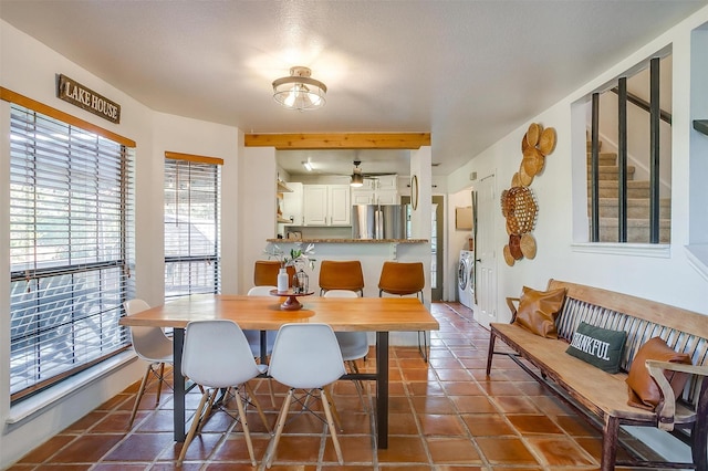 tiled dining area with ceiling fan and washing machine and dryer