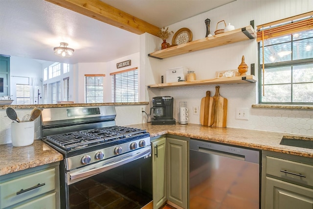 kitchen with stainless steel appliances, tasteful backsplash, light stone counters, green cabinetry, and beamed ceiling