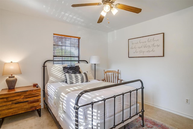 bedroom featuring light carpet and ceiling fan