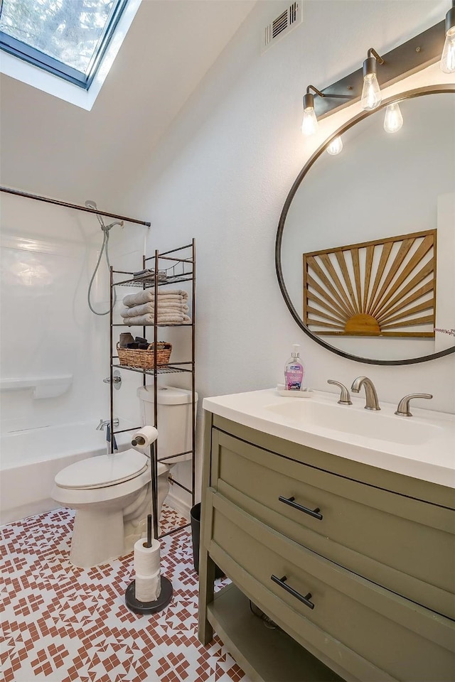 full bathroom with tile patterned floors, toilet, a skylight, shower / tub combination, and vanity