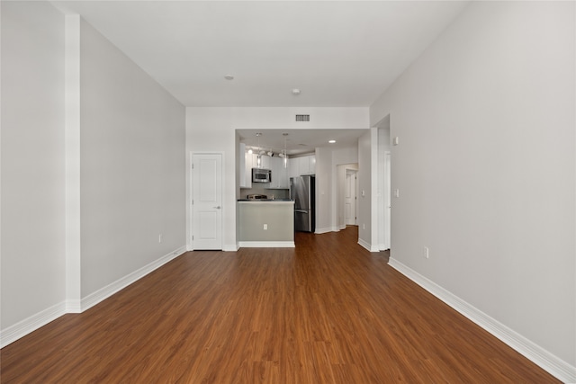 unfurnished living room featuring hardwood / wood-style flooring