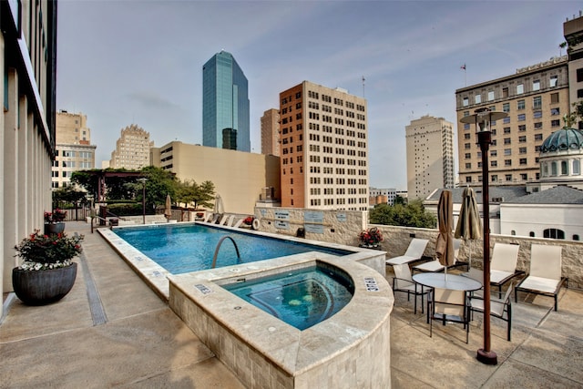 view of pool with a patio area and a community hot tub