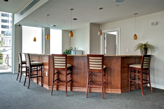 bar featuring carpet and pendant lighting