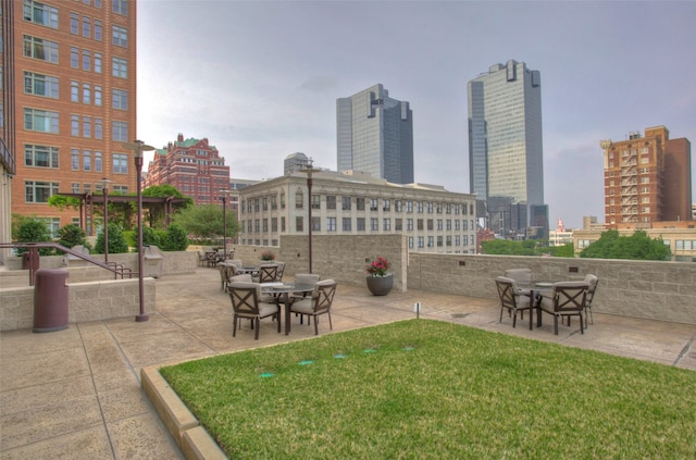 view of home's community with a patio and a yard