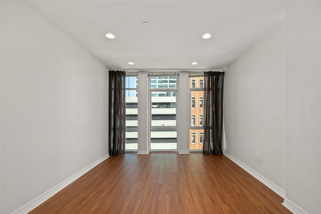 spare room with hardwood / wood-style floors