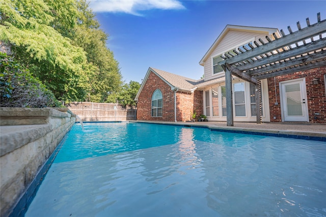 view of pool with a pergola and pool water feature