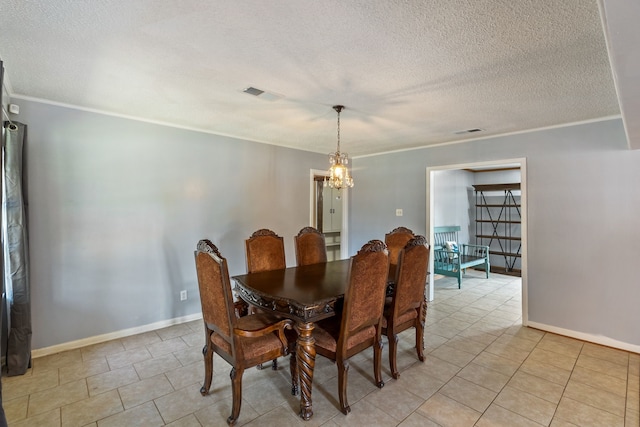 dining space with a textured ceiling, ornamental molding, a notable chandelier, and light tile patterned floors