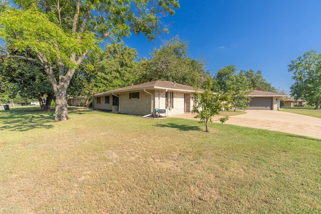 single story home featuring a garage and a front lawn