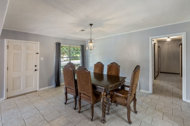 dining room with a textured ceiling, a notable chandelier, and light tile patterned flooring