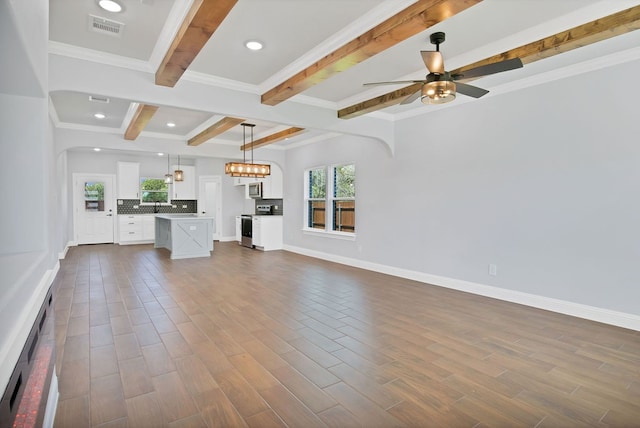 unfurnished living room with beamed ceiling, crown molding, wood-type flooring, and ceiling fan with notable chandelier