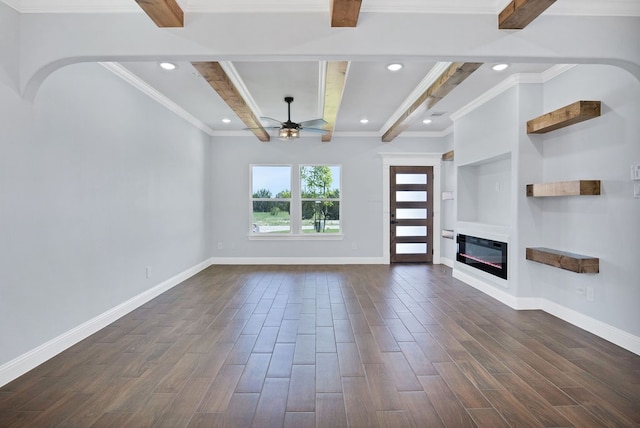 unfurnished living room with beam ceiling, dark hardwood / wood-style flooring, ornamental molding, and ceiling fan