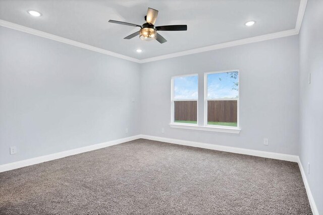 carpeted empty room with ornamental molding and ceiling fan