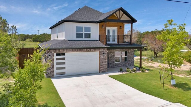 view of front of home featuring a balcony, a garage, and a front lawn