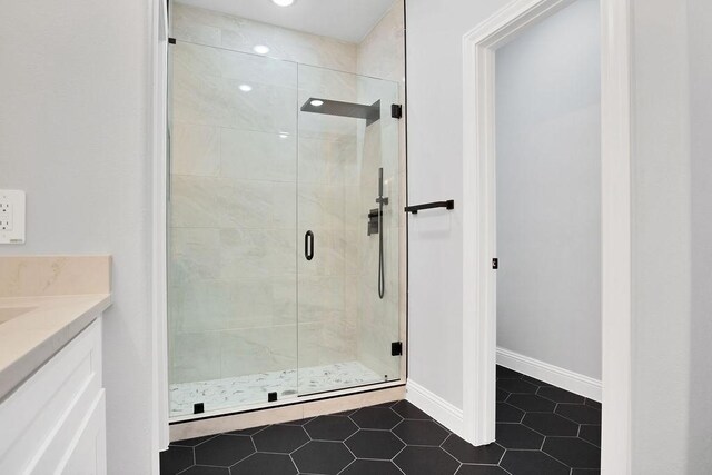 bathroom featuring vanity, tile patterned floors, and an enclosed shower