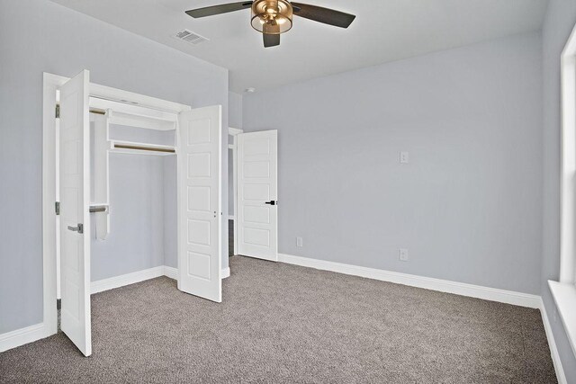 unfurnished bedroom featuring carpet floors, ceiling fan, and a closet