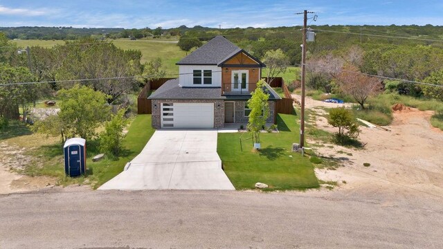 view of front of home featuring a garage and a front lawn