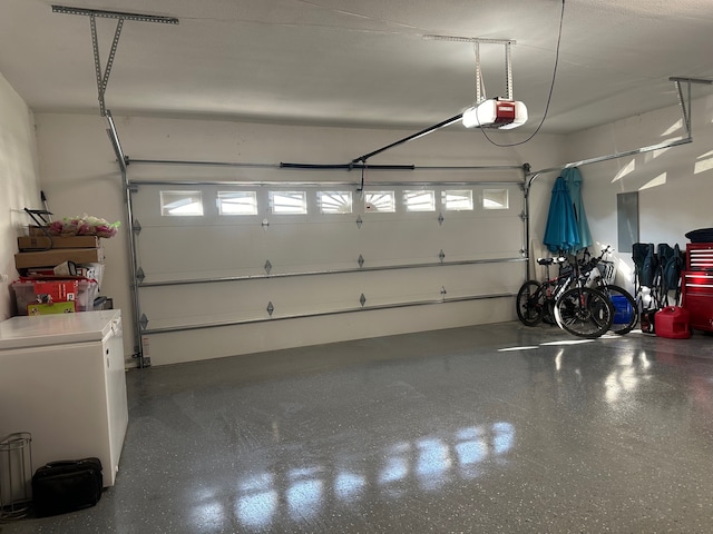 garage featuring washer / clothes dryer and a garage door opener