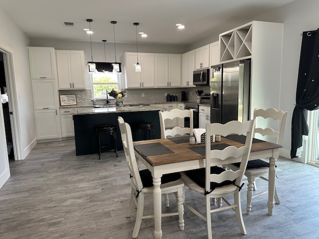 dining room featuring light hardwood / wood-style floors and sink