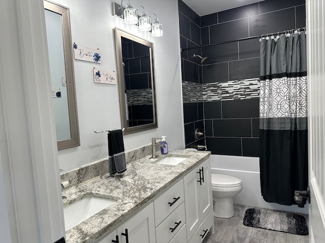 full bathroom with vanity, shower / bath combo, and toilet