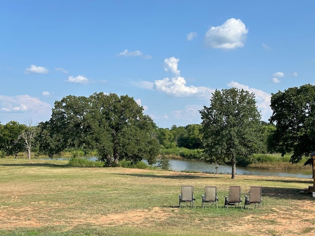 view of community featuring a lawn and a water view