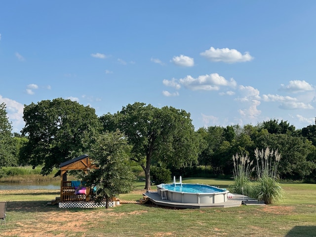 view of pool featuring a lawn