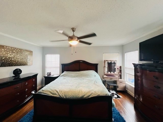 bedroom with dark hardwood / wood-style floors, multiple windows, and ceiling fan