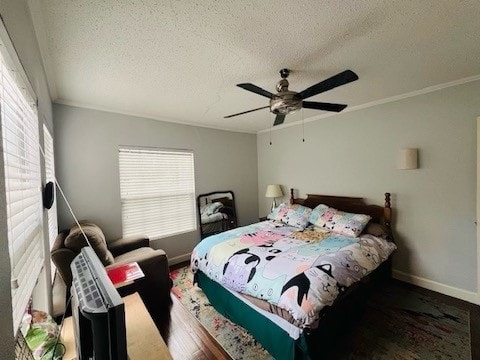 bedroom with hardwood / wood-style flooring, a textured ceiling, ornamental molding, and ceiling fan