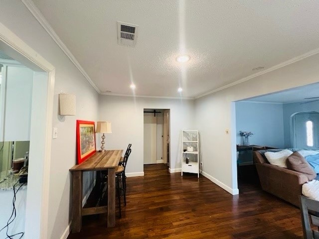 office space featuring dark hardwood / wood-style floors, crown molding, a barn door, and a textured ceiling