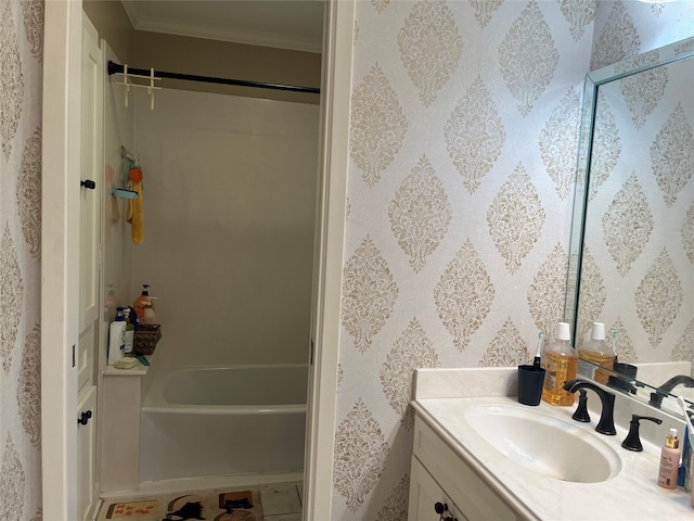 bathroom featuring ornamental molding, vanity, and shower / bathing tub combination