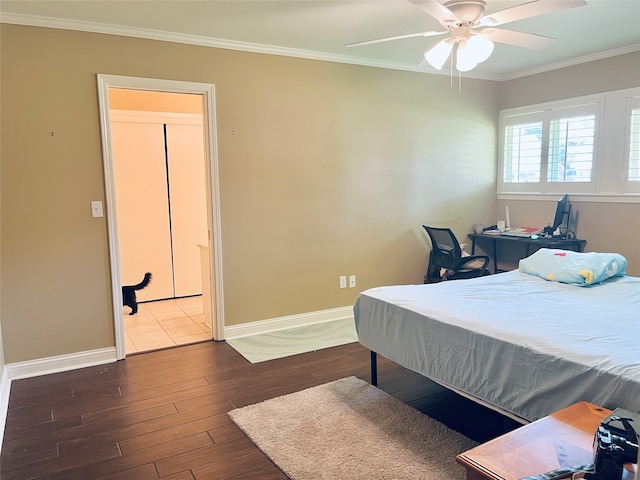 bedroom featuring dark hardwood / wood-style floors, ceiling fan, and ornamental molding