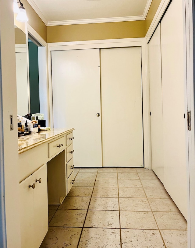 bathroom featuring vanity, tile patterned floors, and crown molding