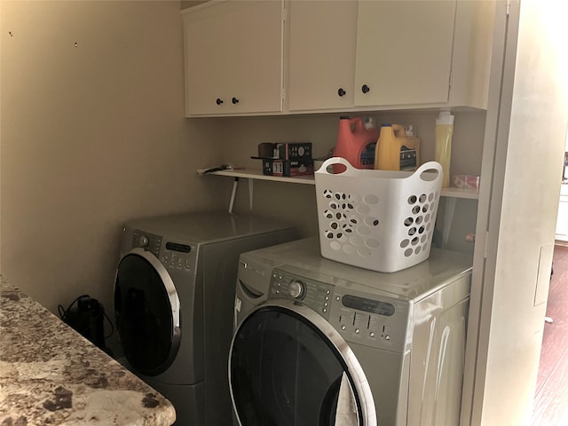 washroom featuring cabinets and independent washer and dryer