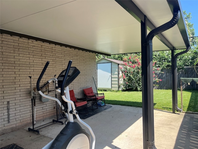 workout room featuring brick wall