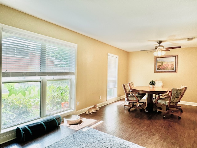 dining space with hardwood / wood-style floors and ceiling fan