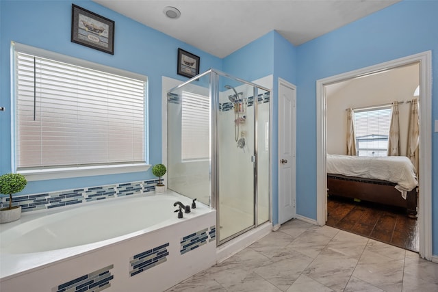 bathroom featuring plus walk in shower and hardwood / wood-style floors