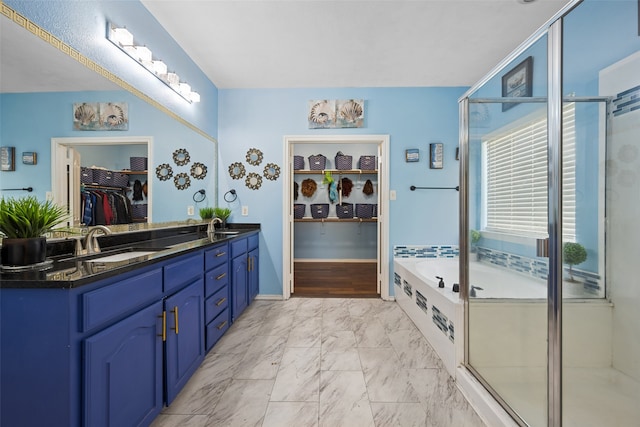 bathroom with dual bowl vanity, tile patterned floors, and independent shower and bath