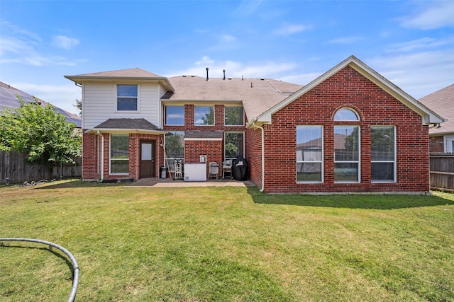 back of property with a patio and a yard