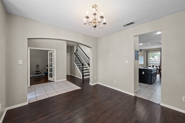 entryway featuring hardwood / wood-style flooring and a chandelier