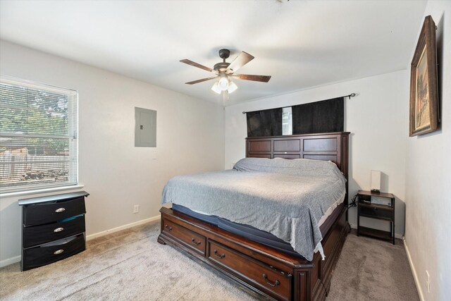 bedroom with light carpet, electric panel, and ceiling fan