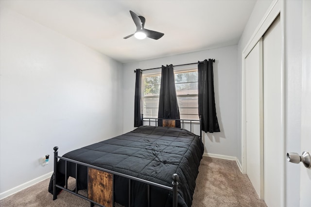 bedroom with light carpet, ceiling fan, and a closet