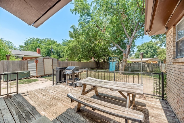 deck featuring a storage shed and grilling area