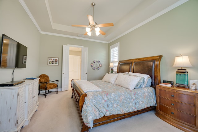 carpeted bedroom featuring ceiling fan, crown molding, and a raised ceiling